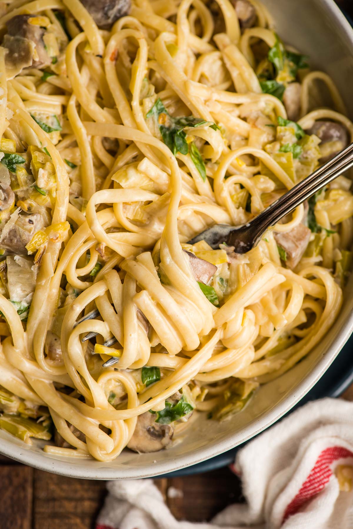 Fork twirling creamy linguine, mushroom, and leek pasta.