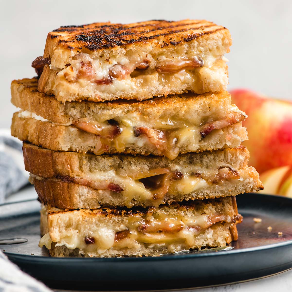 Stack of Apple Brie Grilled Cheese on a navy plate.