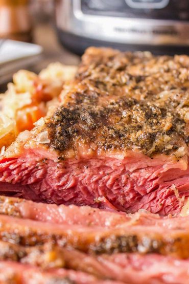 Corned beef sliced to reveal the tender, pink interior.