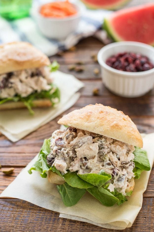 Chicken salad sandwiches with cranberries and pistachios on ciabatta bread.
