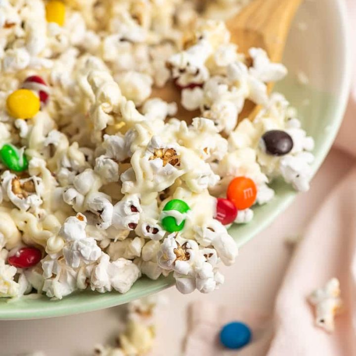 scoop of white chocolate popcorn and M&MS