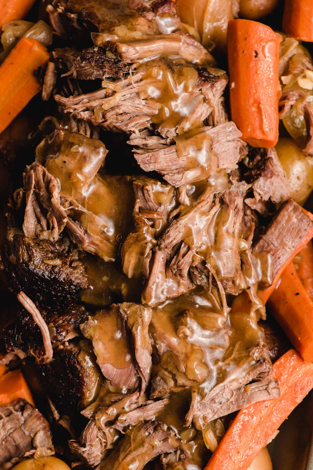 Slow cooker pot roast smothered in gravy.