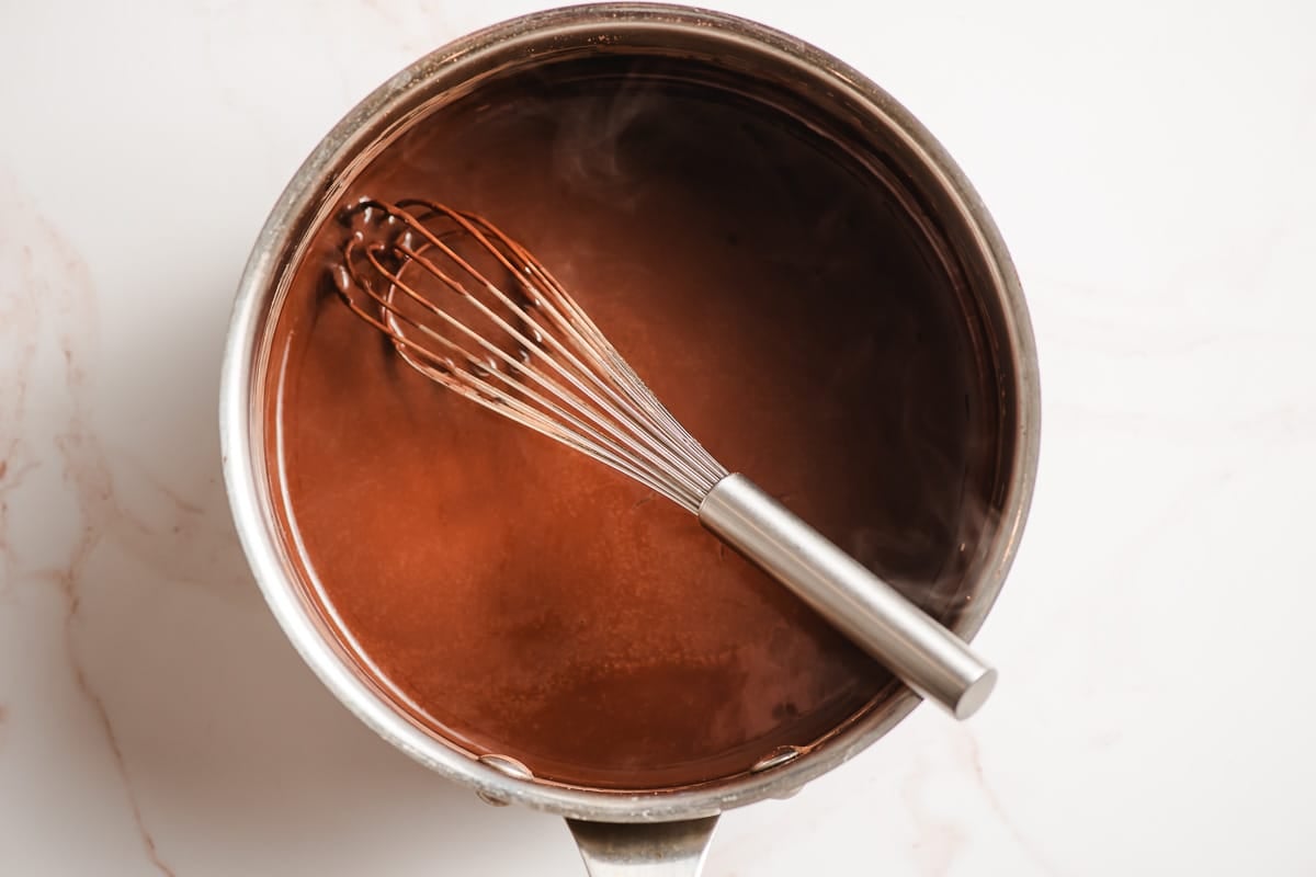 Coffee and cocoa stirred together in a sauce pot.