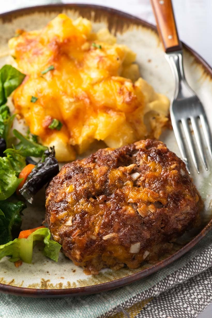 mini meatloaf on a plate with salad and cheesy potatoes