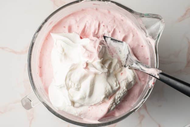 Cool whip stirred into whipped egg whites and strawberries.