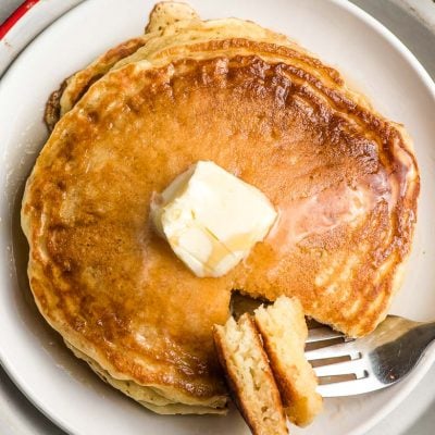 fork stabbing a piece of fluffy pancakes