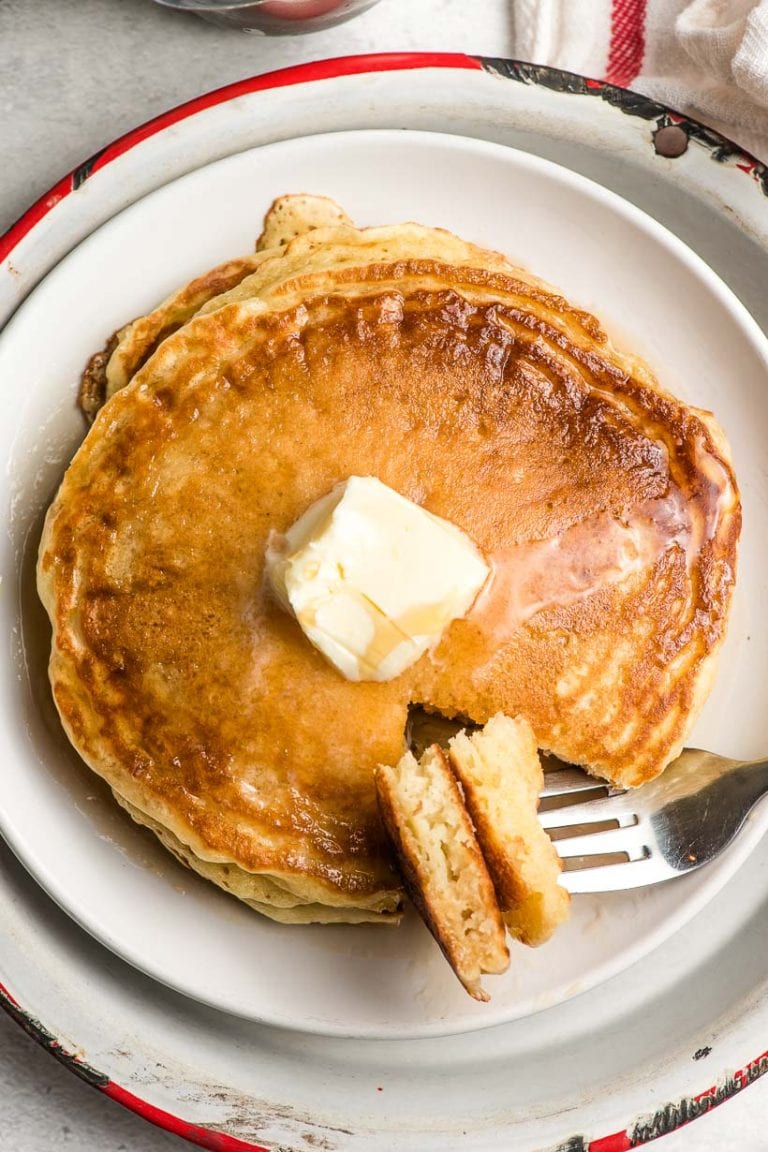 fork stabbing a piece of fluffy pancakes