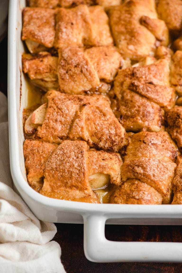 white dish full of crescent roll apple dumplings