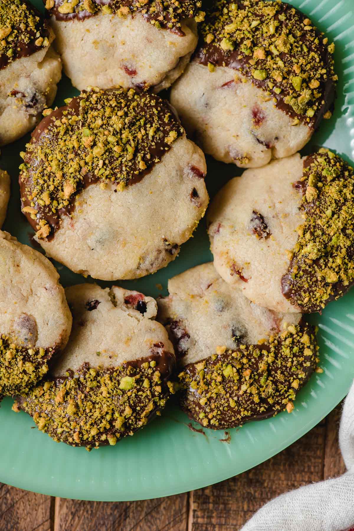 Vintage jadette plate with chocolate cranberry pistachio shortbread cookies on top.