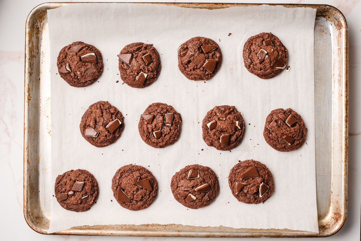 Baked Andes Mint Cookies on a parchment lined baking sheet.