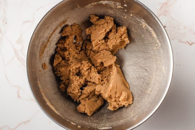Butter and sugar after being beaten together in a mixing bowl.