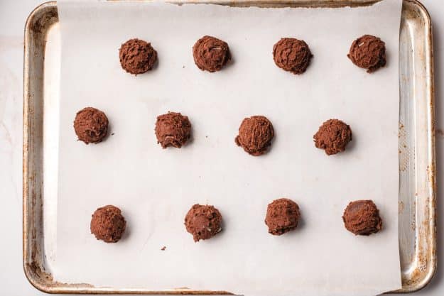Andes mint cookie batter scooped out onto a baking sheet.