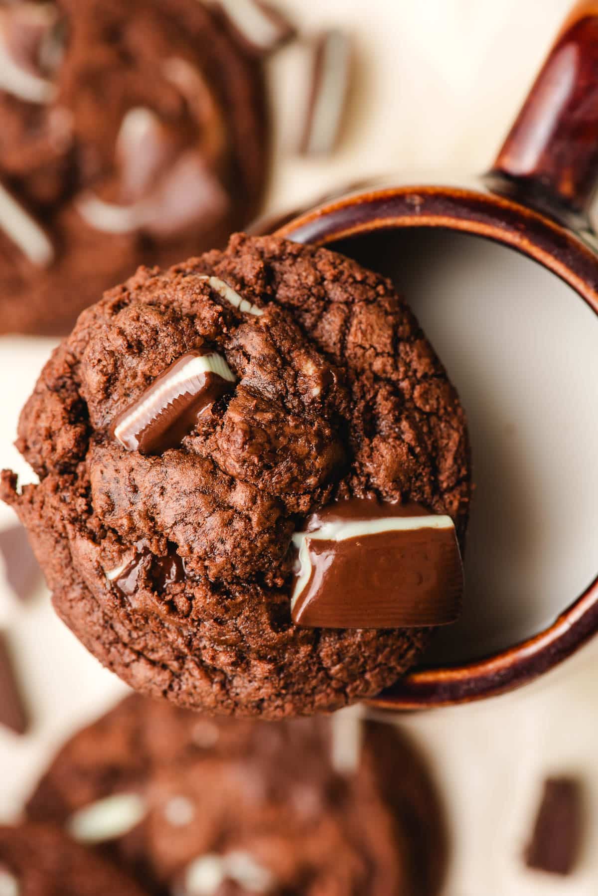 Andes chocolate mint cookie sitting on top of a mug of milk.