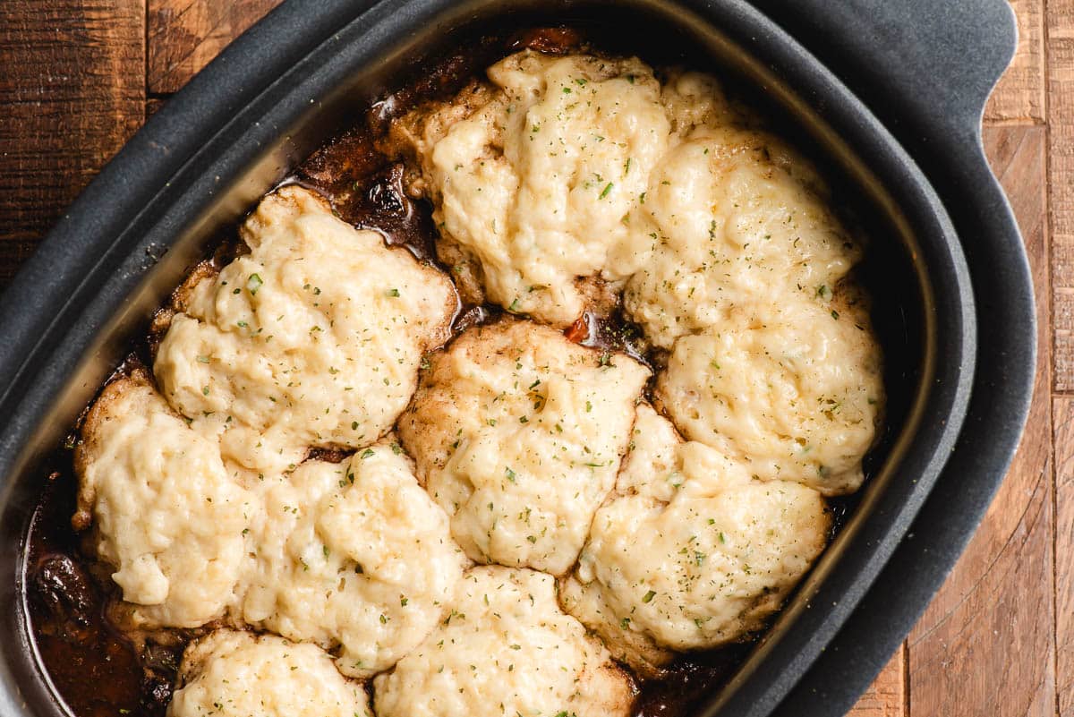 Crock pot beef stew and dumplings, just made and still shown in the crock pot.