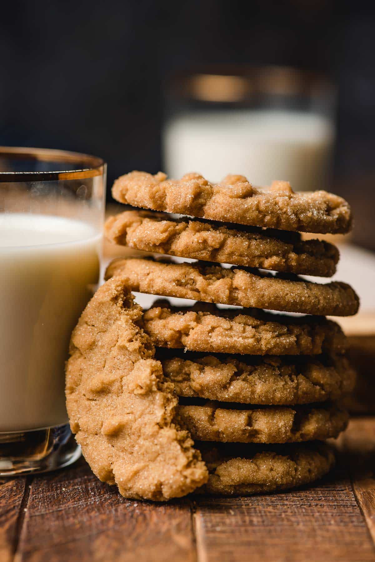 Stack of soft and chewy peanut butter cookies next to a glass of milk.