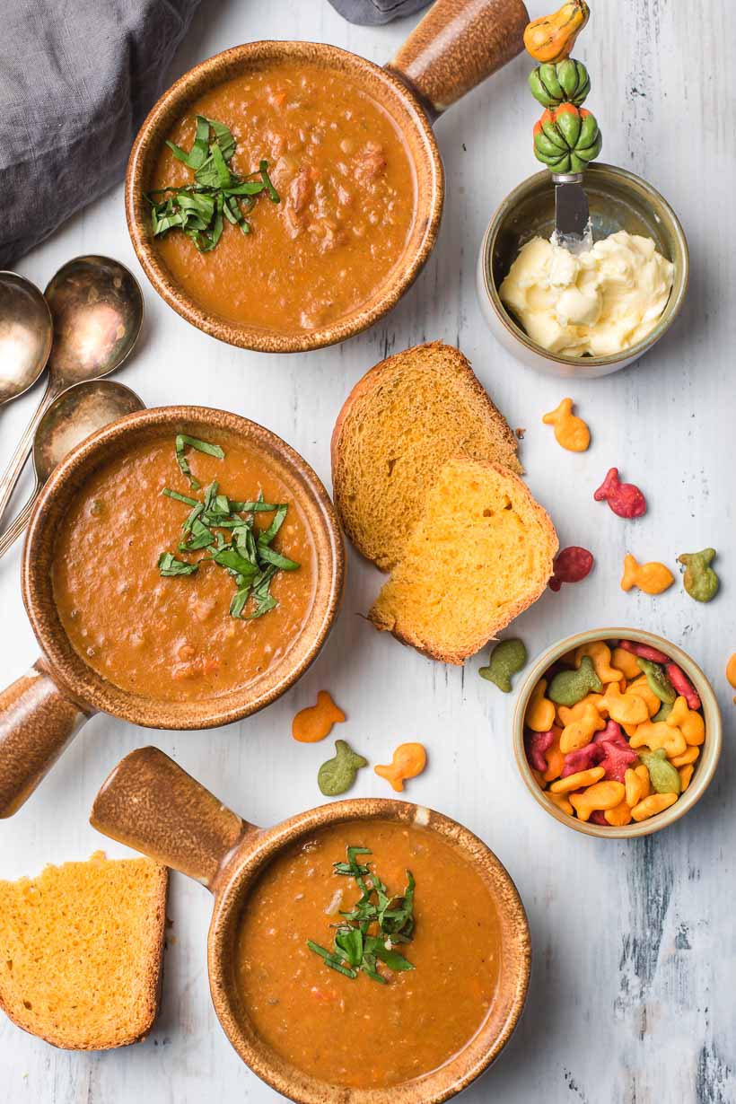 3 bowls of vegan lentil soup with bread