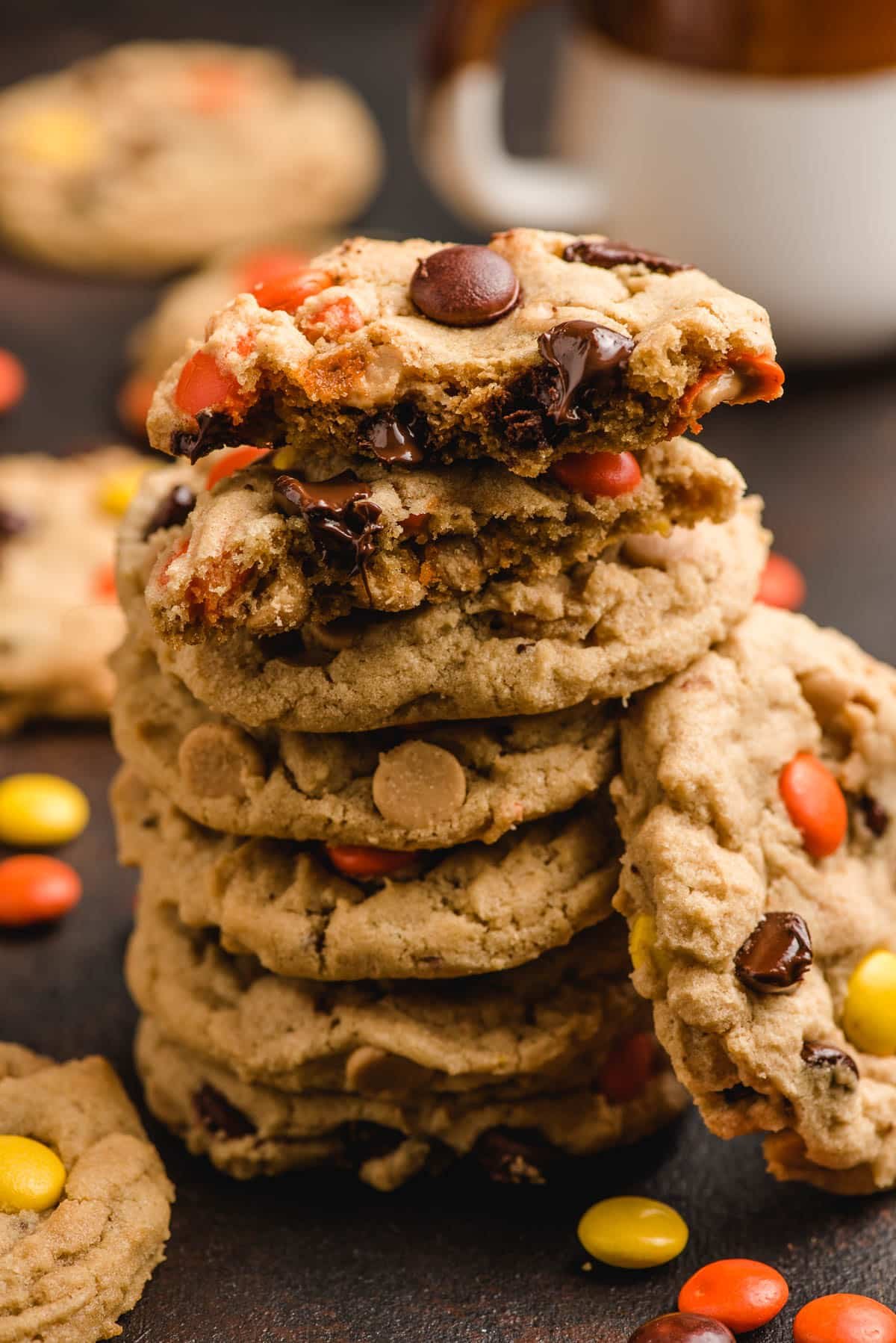 Stack of peanut butter cookies with Reese's pieces and chocolate chips.