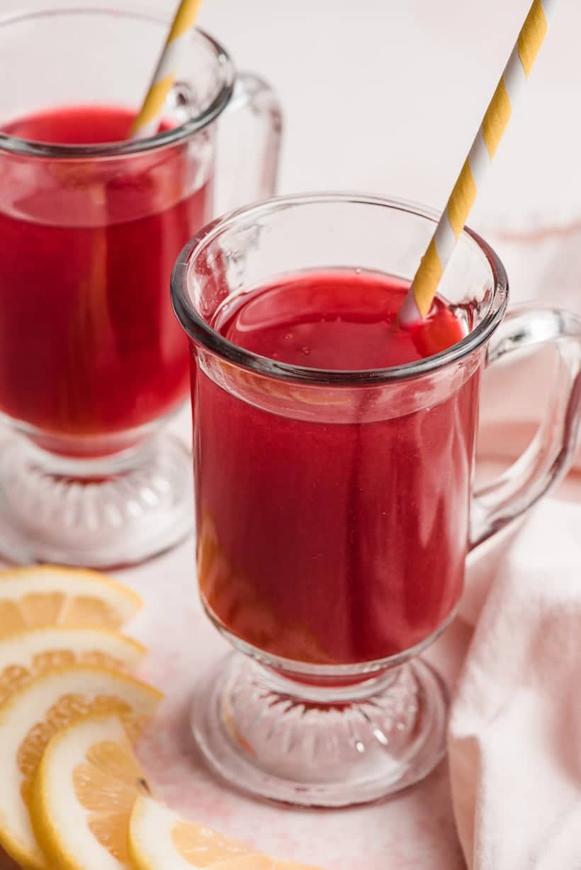 bright pink raspberry cordial with a striped lemon straw