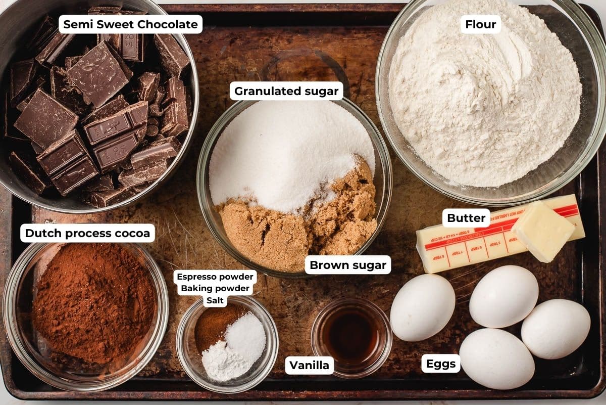 Ingredients for brownie cookies in prep bowls on a baking sheet.