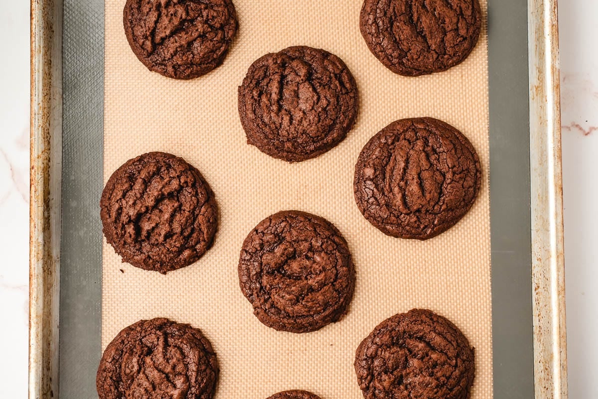 Freshly baked brownie cookies on a sheet pan.