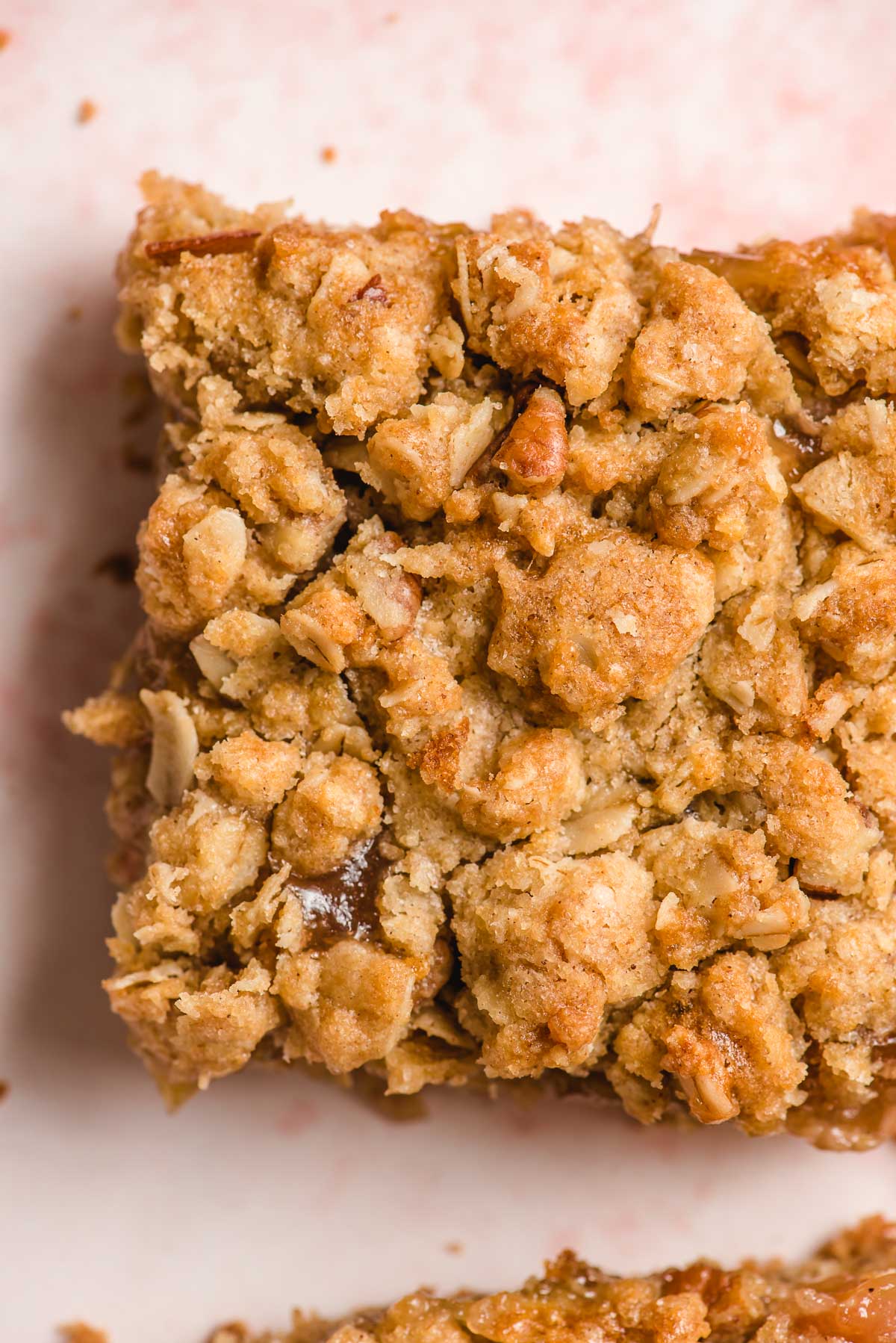 Up close photo highlighting the buttery crumble on top of a rhubarb bar.