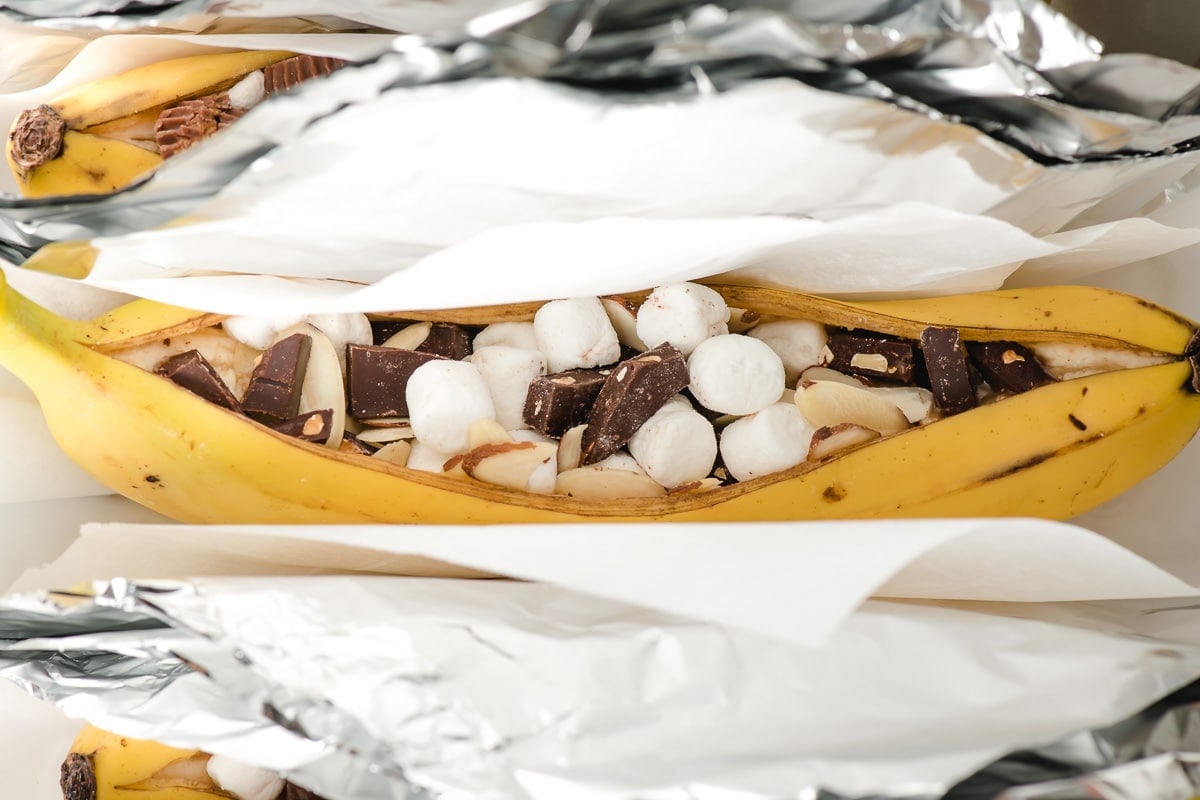 Banana stuffed with marshmallows and chocolate, ready to be wrapped in foil and grilled.