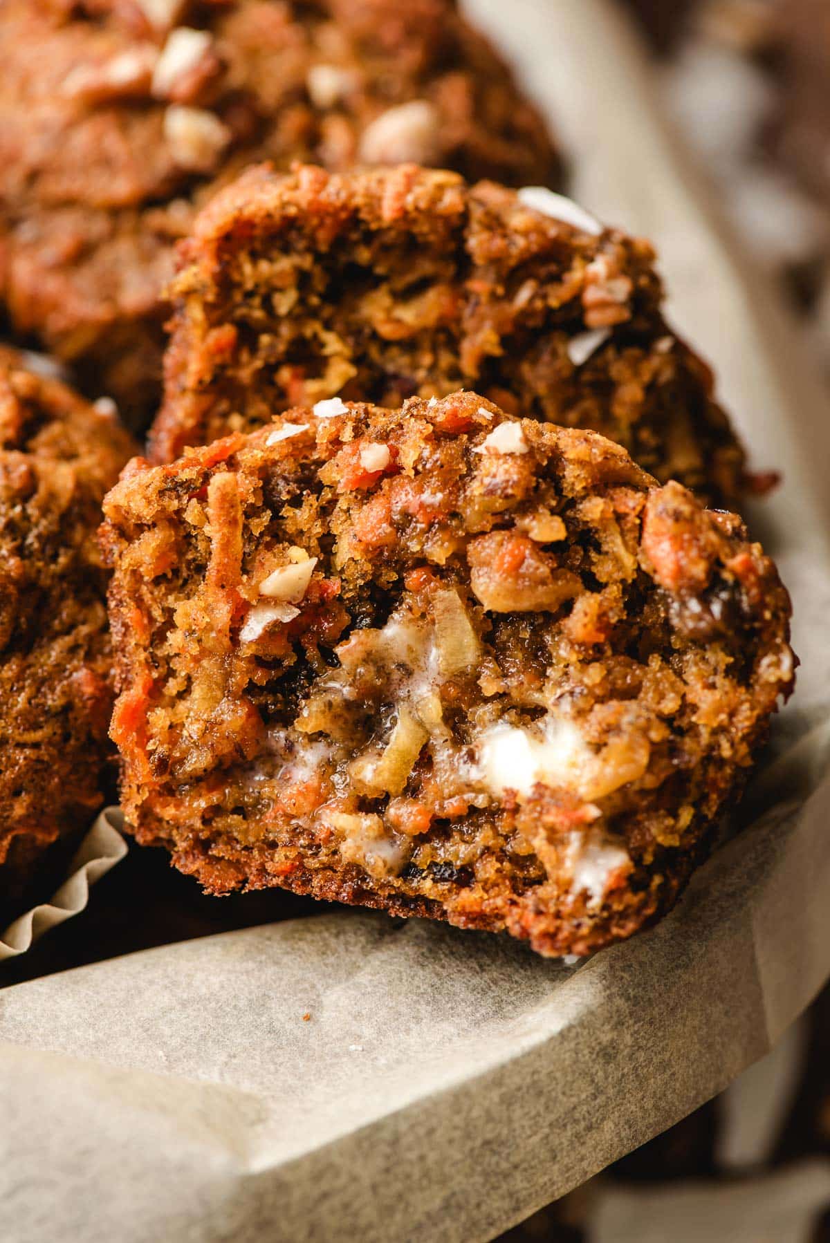 A sliced morning glory muffin spread with butter.