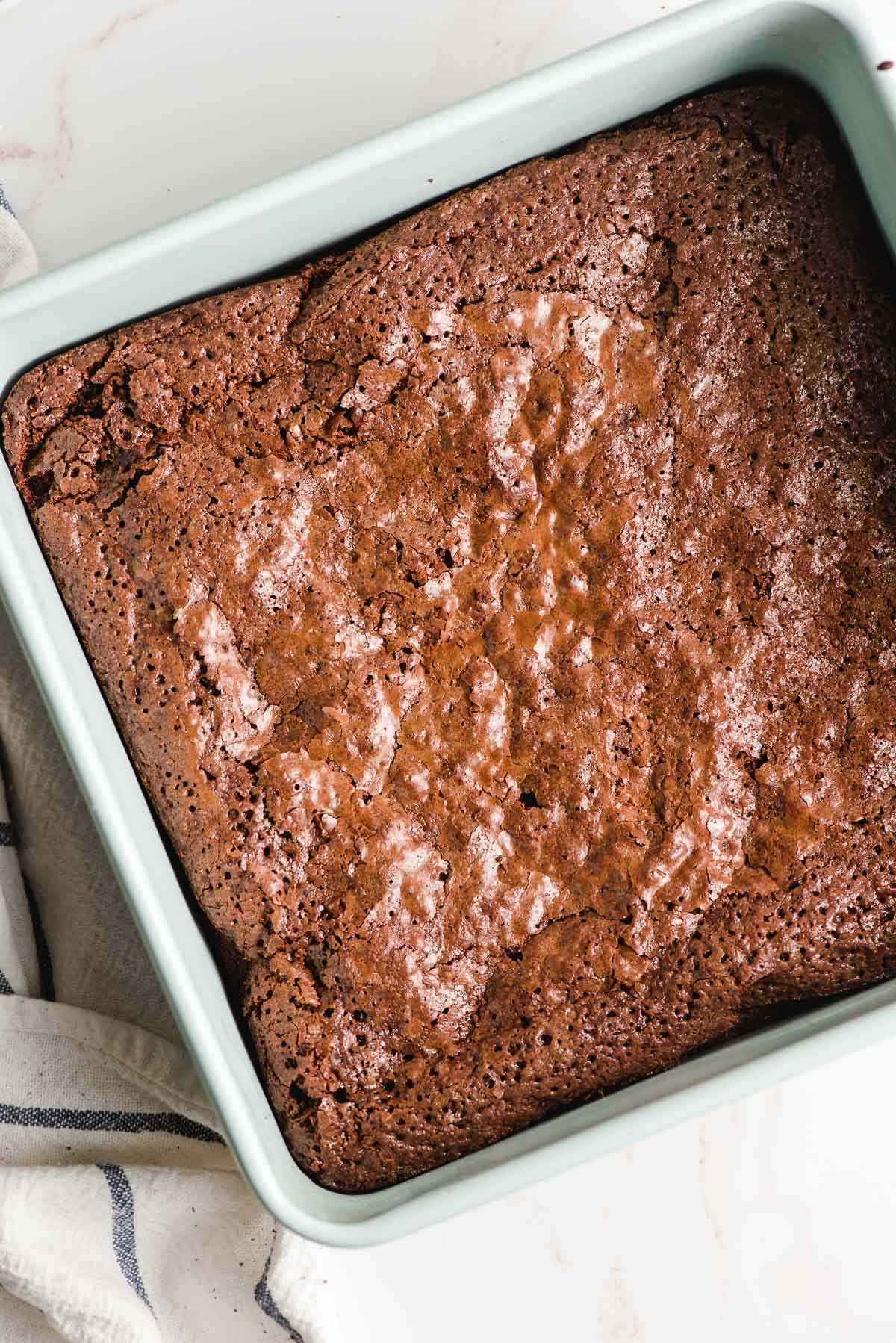 Fresh baked brownies in a square pan.