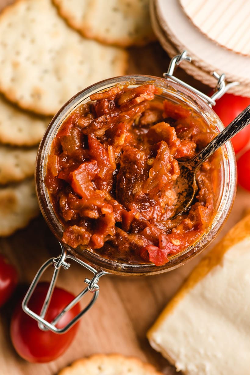 Small spoon in a jar of tomato jam.