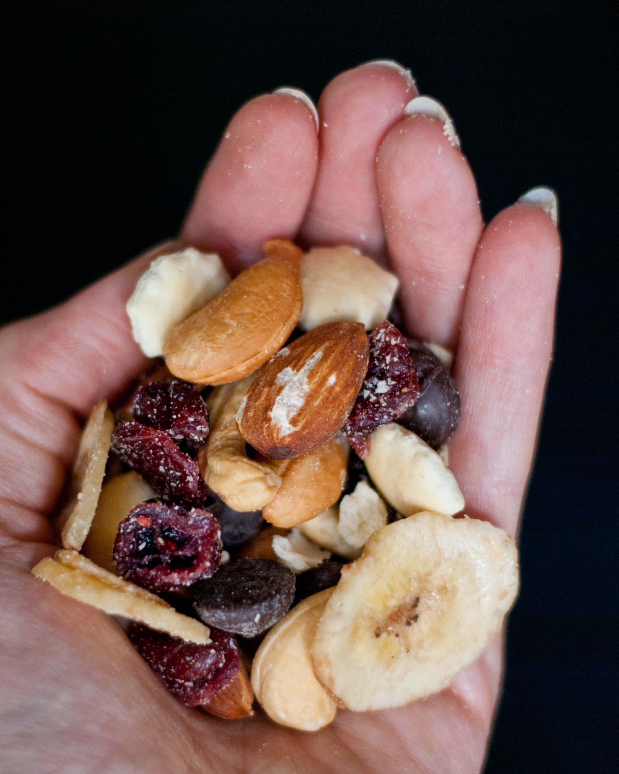 a cloesup image of a handful of healthy trail mix