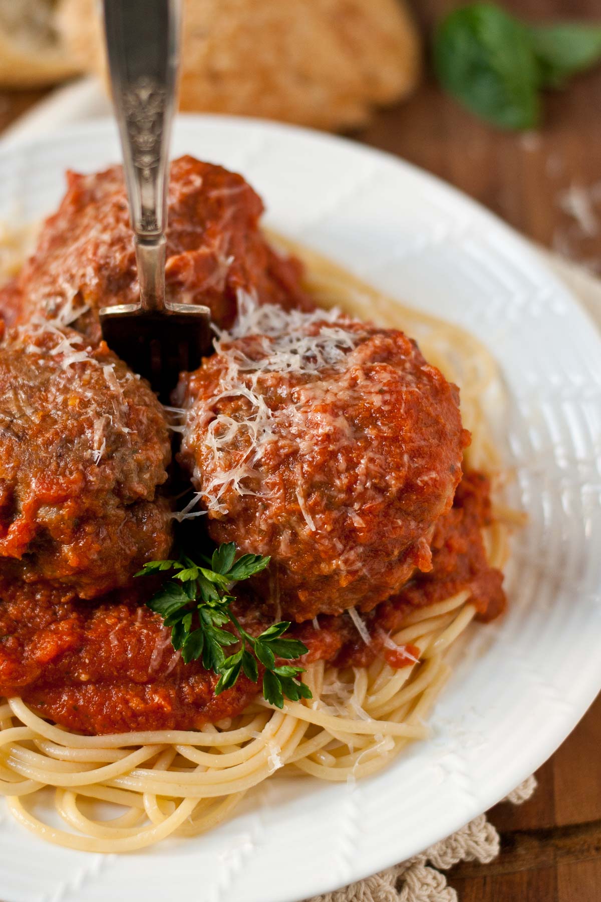 Tomato sauce and homemade meatballs on a bed of spaghetti.