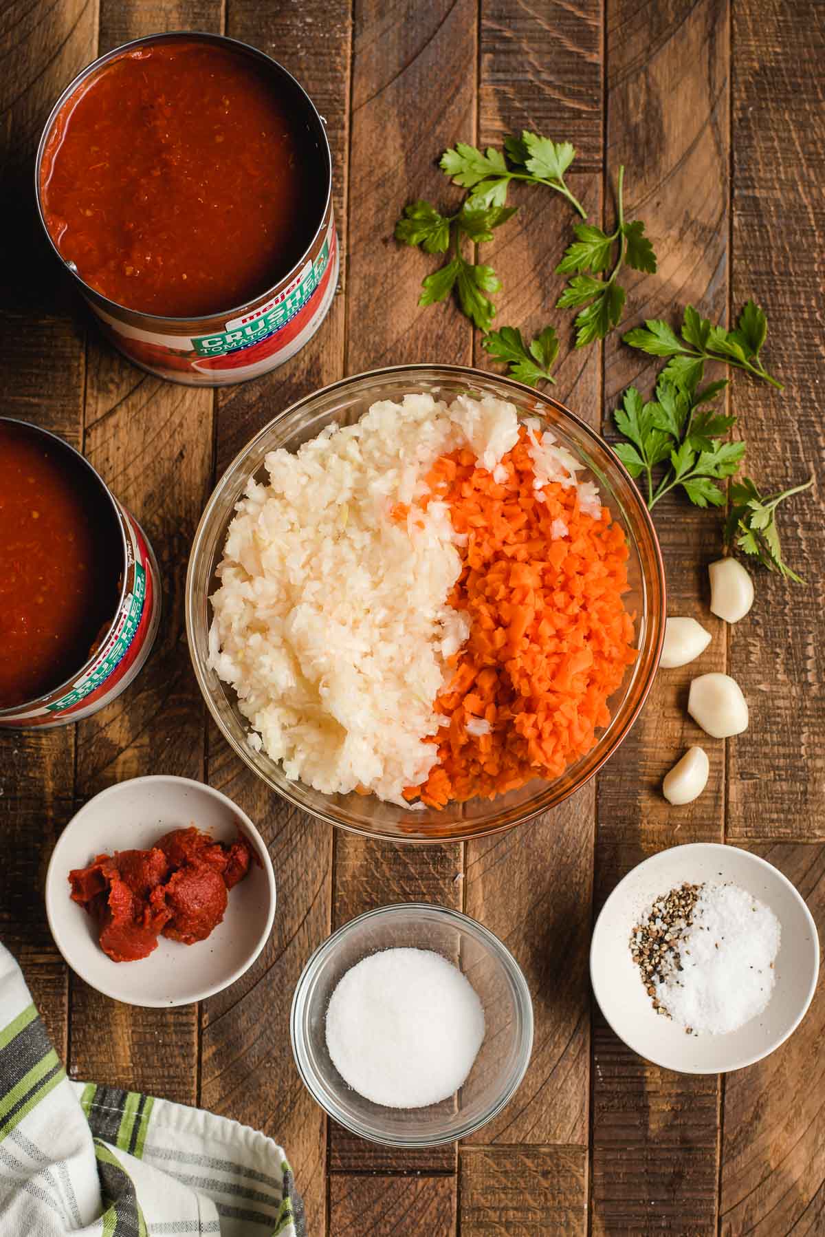 Ingredients for homemade spaghetti sauce shown in bowls.
