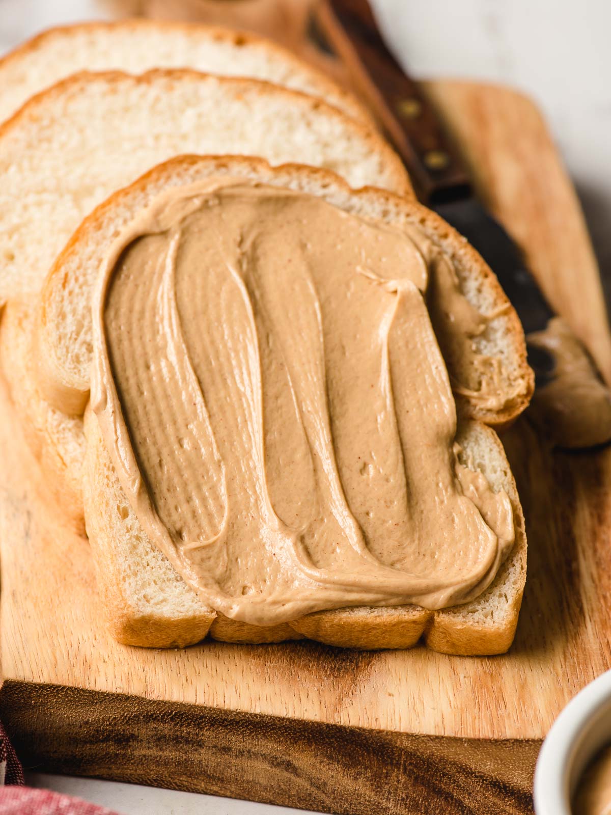 Slice of white bread with Amish peanut butter spread.