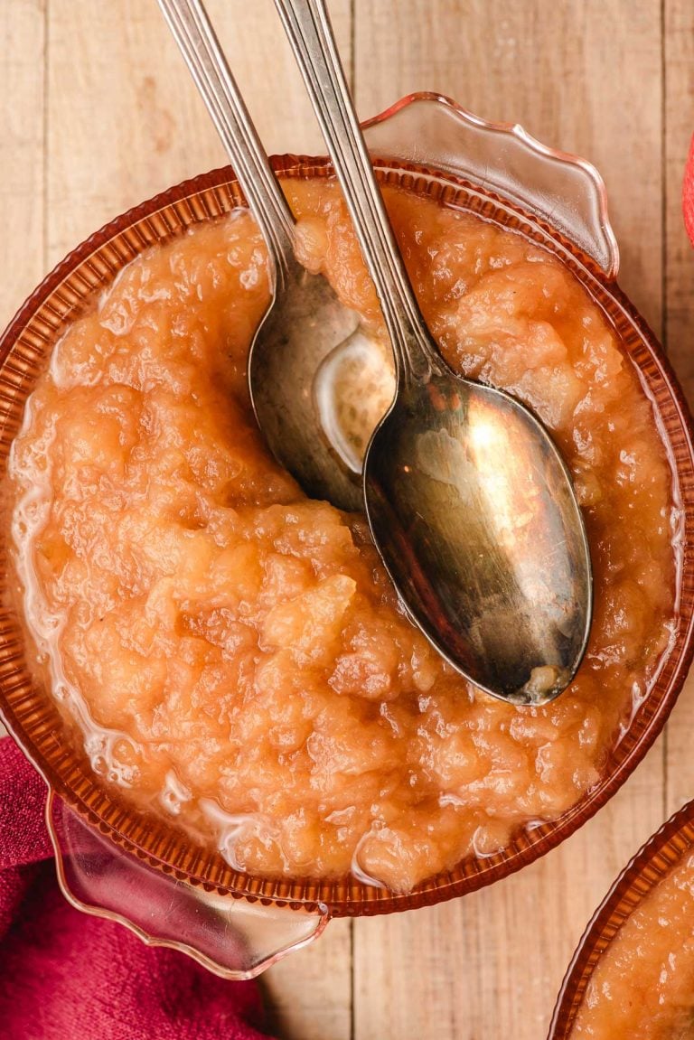 Chunky cinnamon applesauce in a bowl with two spoons.