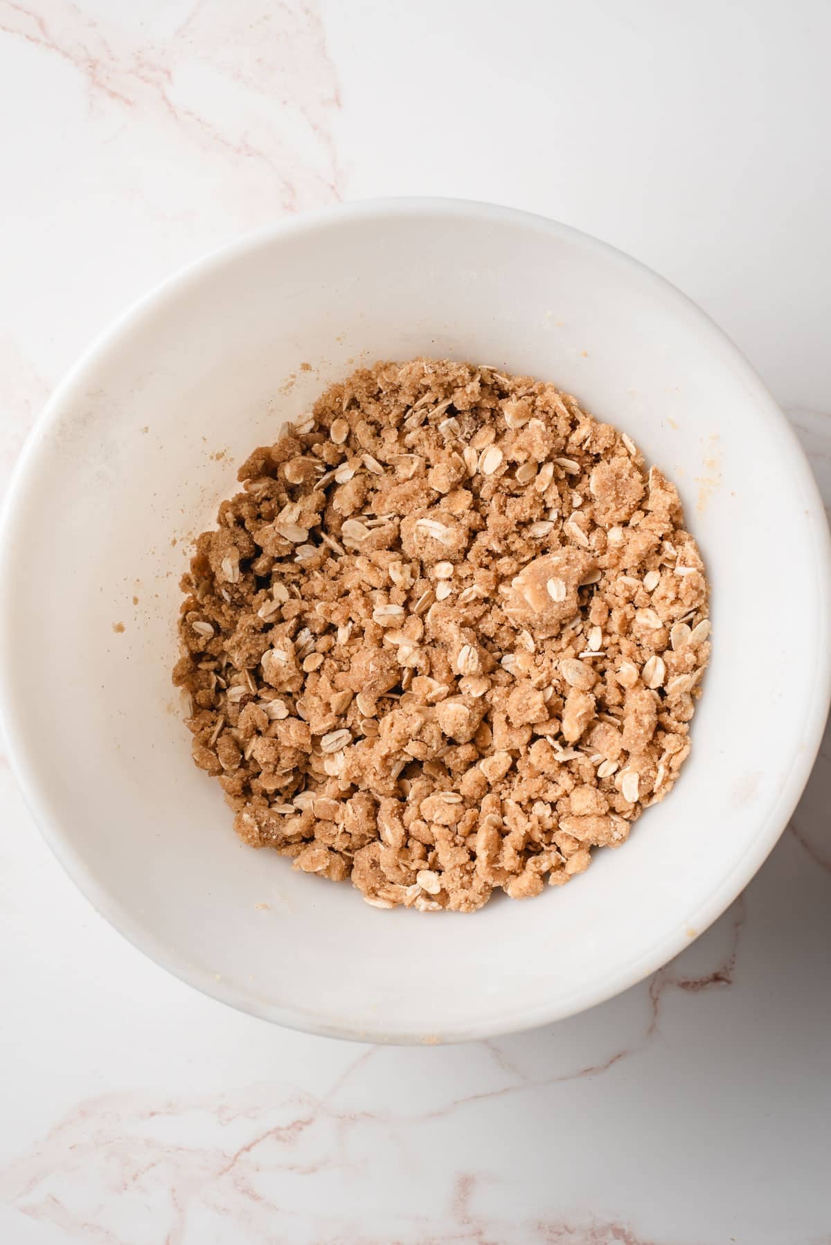 Buttery oat crisp topping in a bowl.
