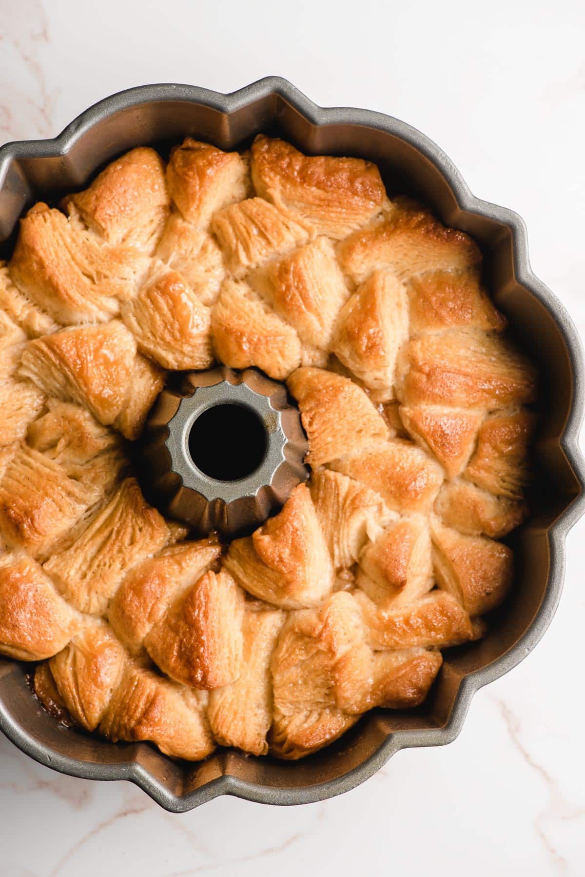 Caramel monkey bread shown in a bundt pan after being baked.