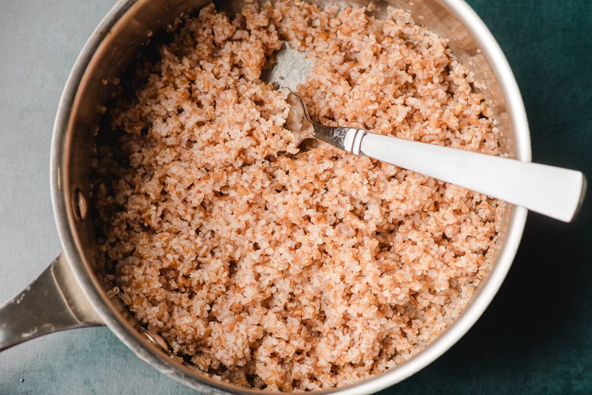 Cooked bulgur in a sauce pot.