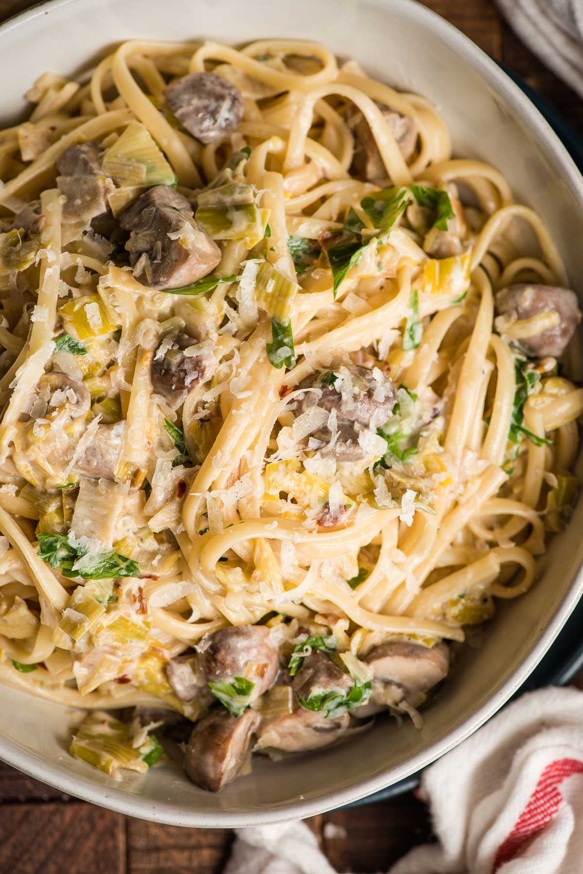 Creamy Mushroom and Leek Pasta in a white bowl.