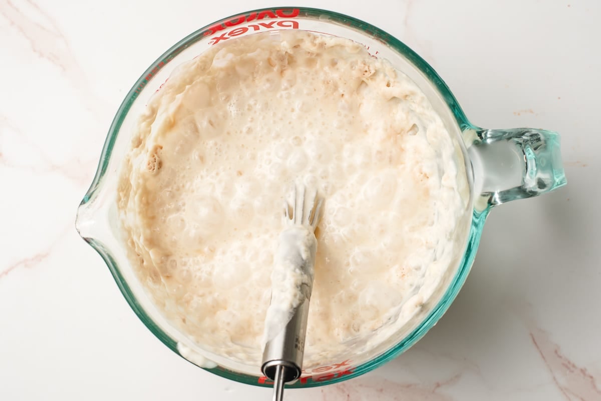Yeast starter in a glass measuring cup.