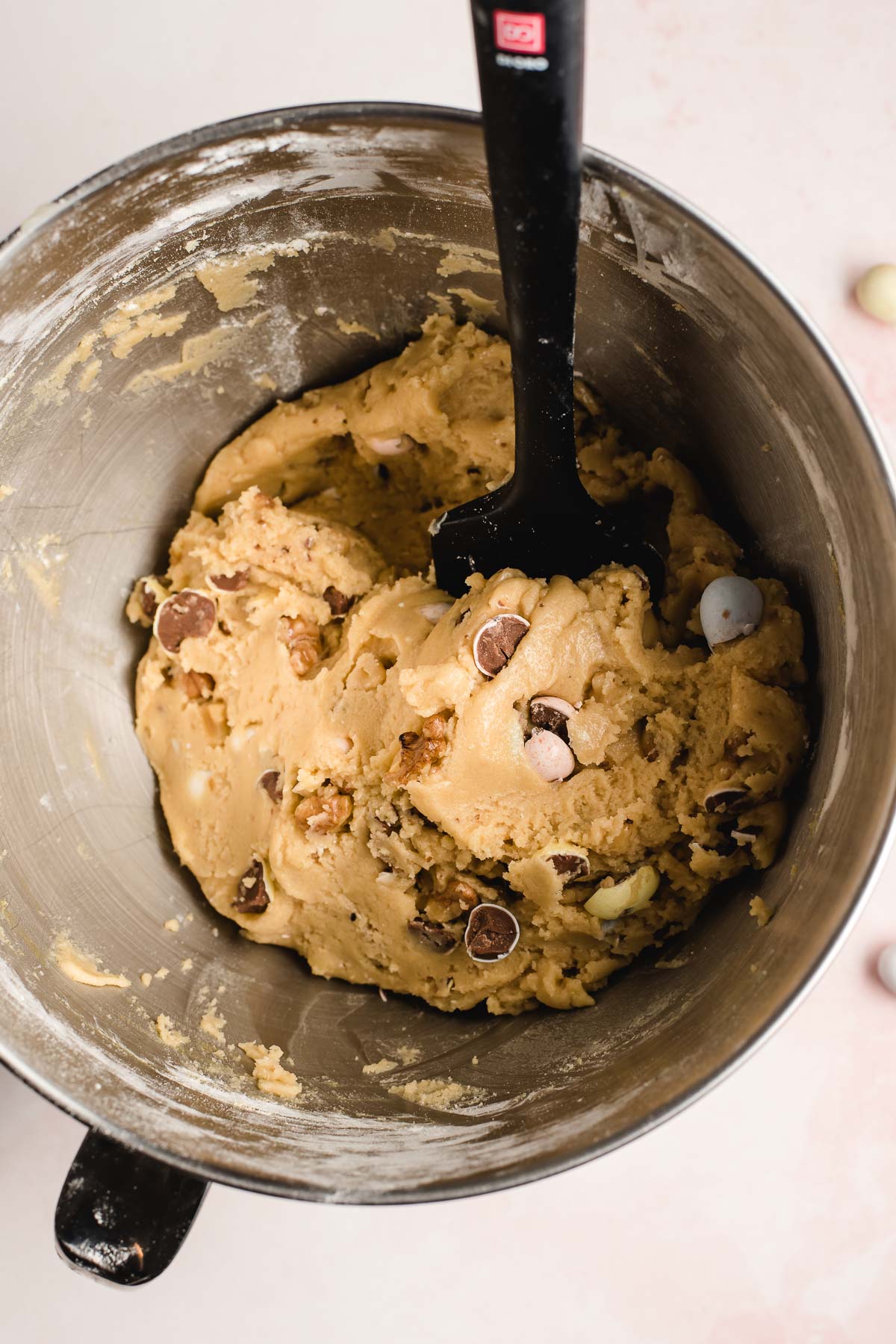 cadbury egg cookie dough shown in the bowl of an electric mixer.