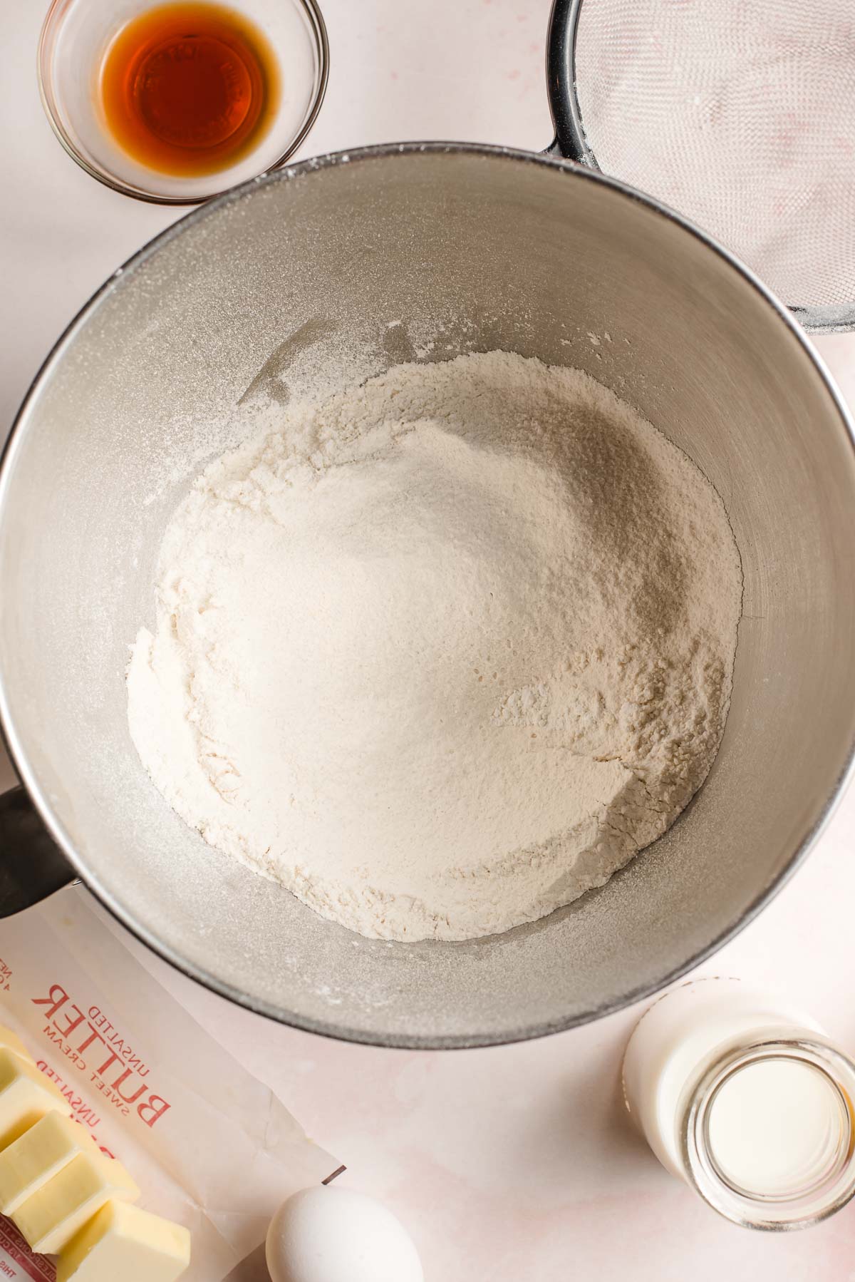 Sifted flour, baking powder, and salt in the bowl of an elxtric mixer.