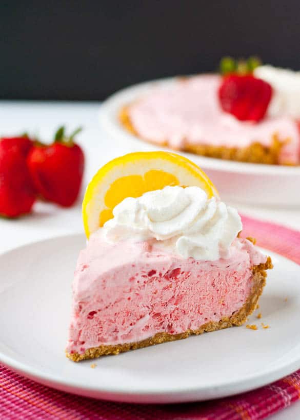 This Frozen Strawberry Lemonade Pie is so light and fluffy. The perfect no bake dessert for a hot summer night.