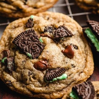 A Mint Oreo Chocolate Chip Cookie on a cooling rack.