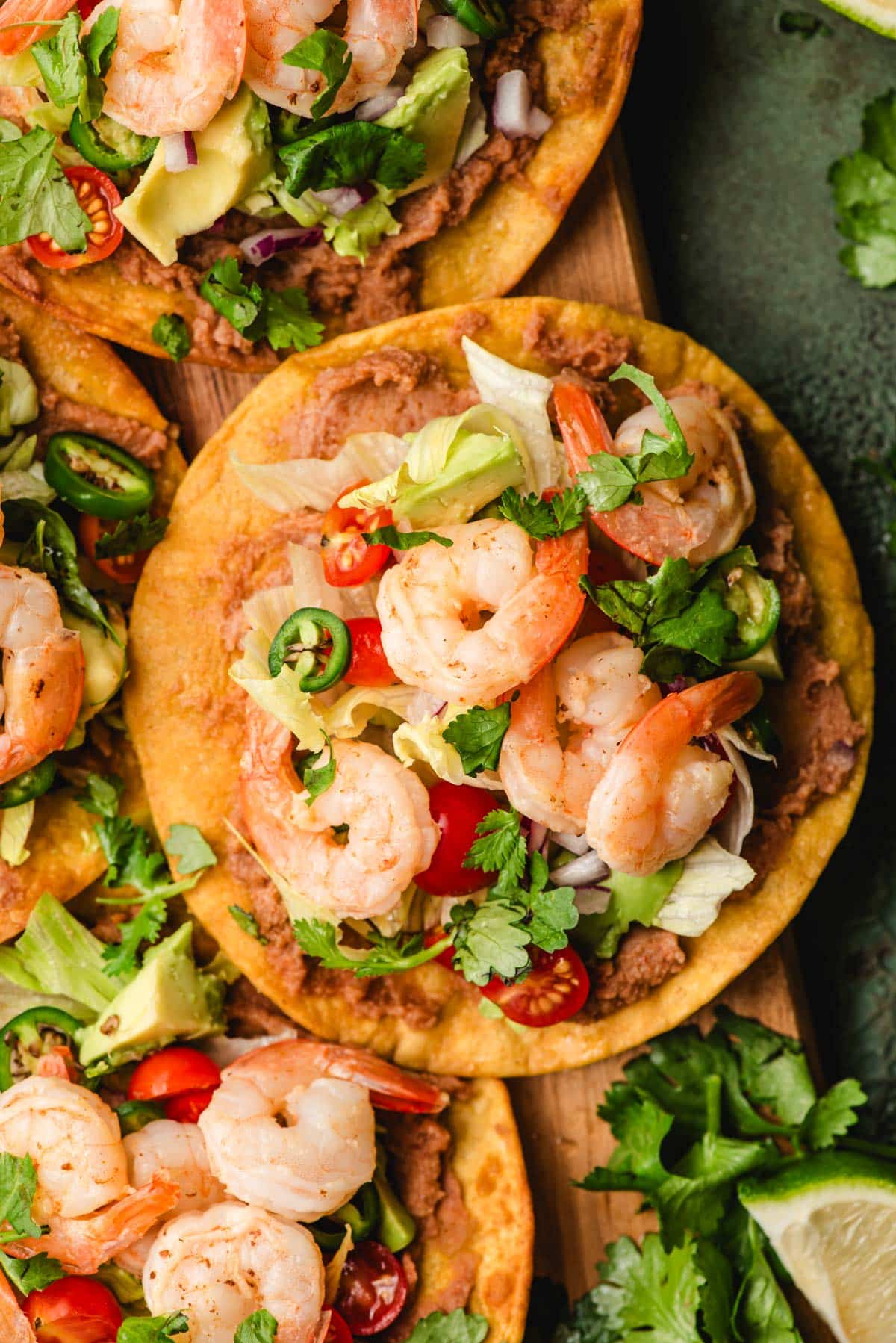 Shrimp tostada with refried beans and fresh veggies.