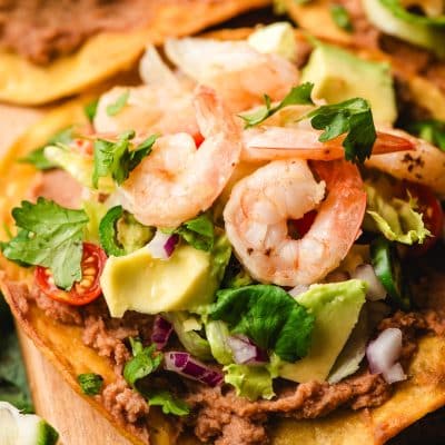 Tostadas with shrimp, refried beans, and lots of fresh veggie toppings.