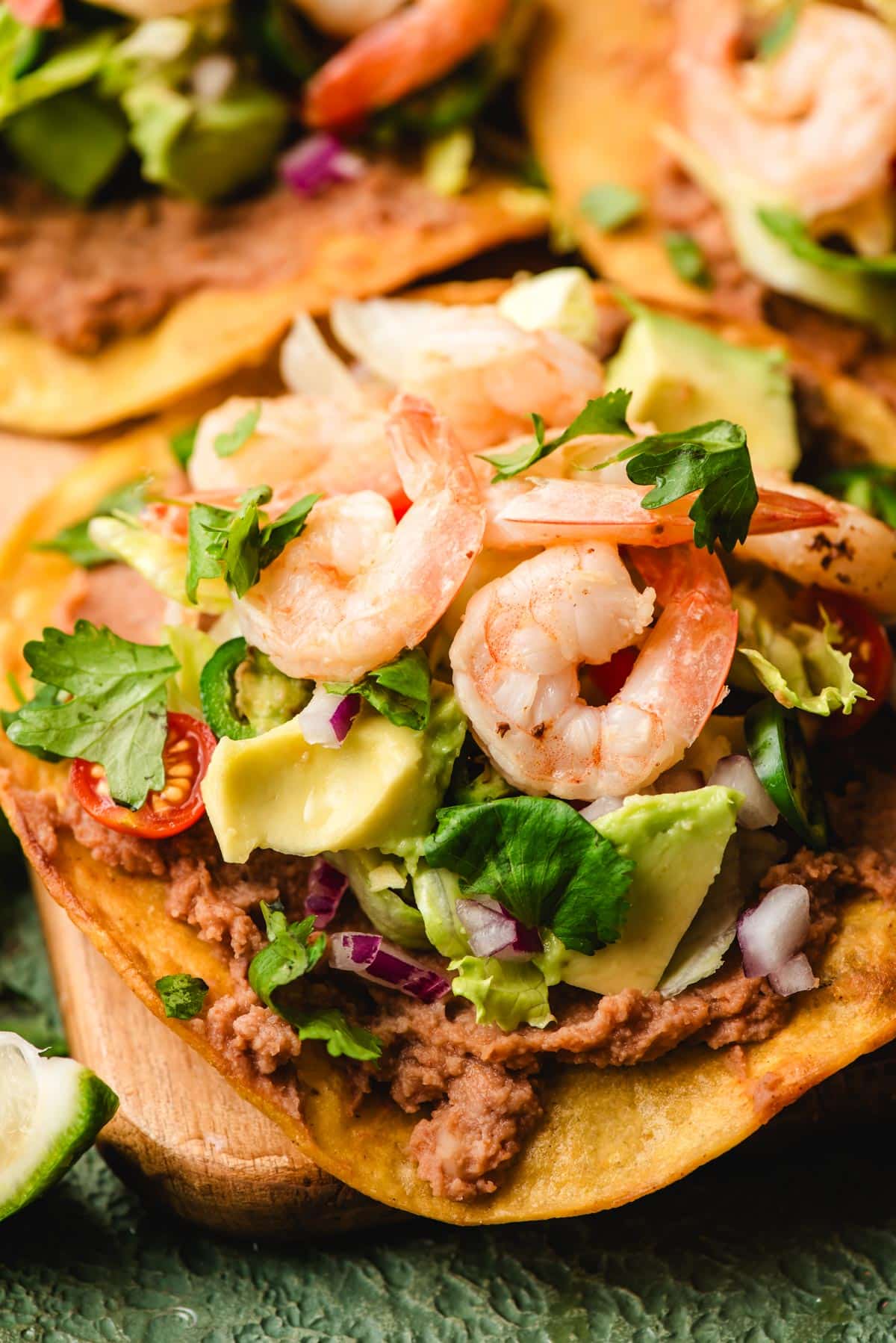 Tostadas with shrimp, refried beans, and lots of fresh veggie toppings.