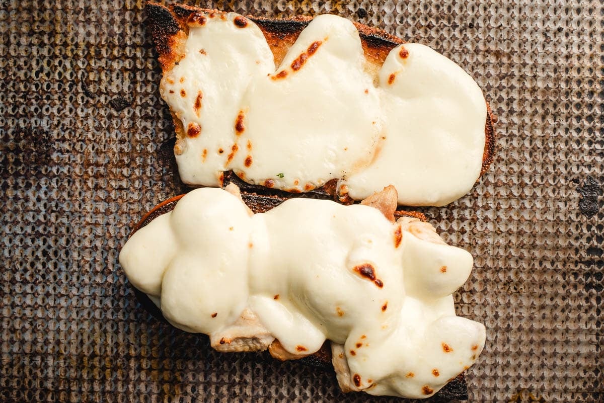 Broiled mozzarella cheese on top of French bread halves.