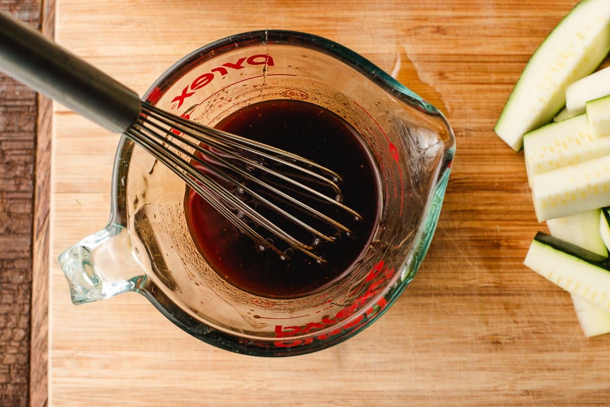 Soy sauce, sriracha, and honey stirred together in a measuring cup.
