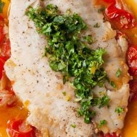 Tilapia filet poached in tomato broth with fresh parsley and mint.