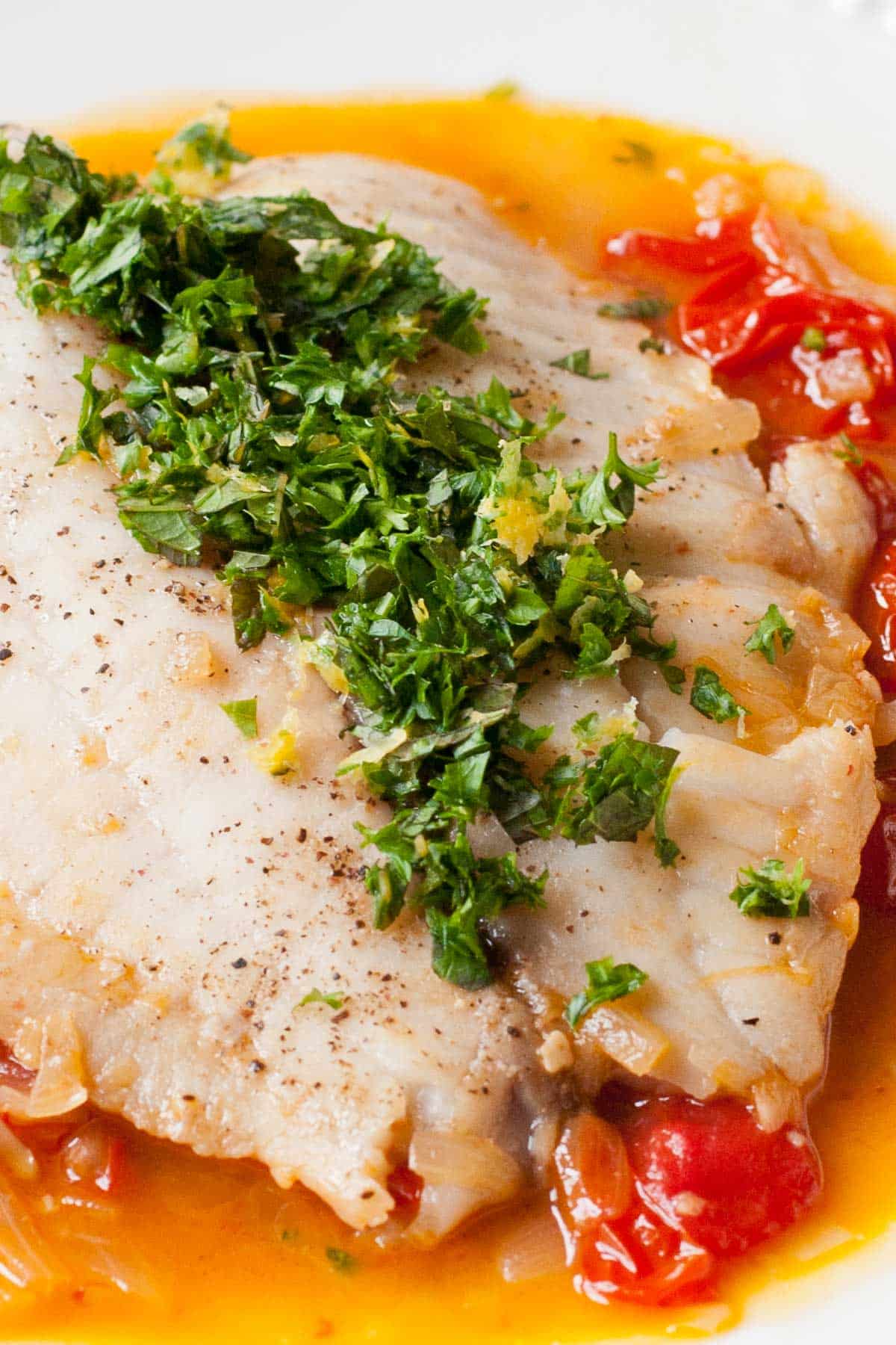 Tilapia poached in a tomato and white wine broth, served with fresh basil and mint.